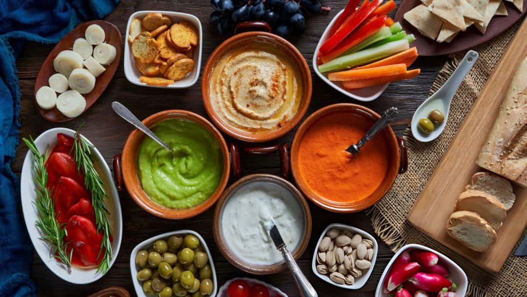 A spread of dips with sides