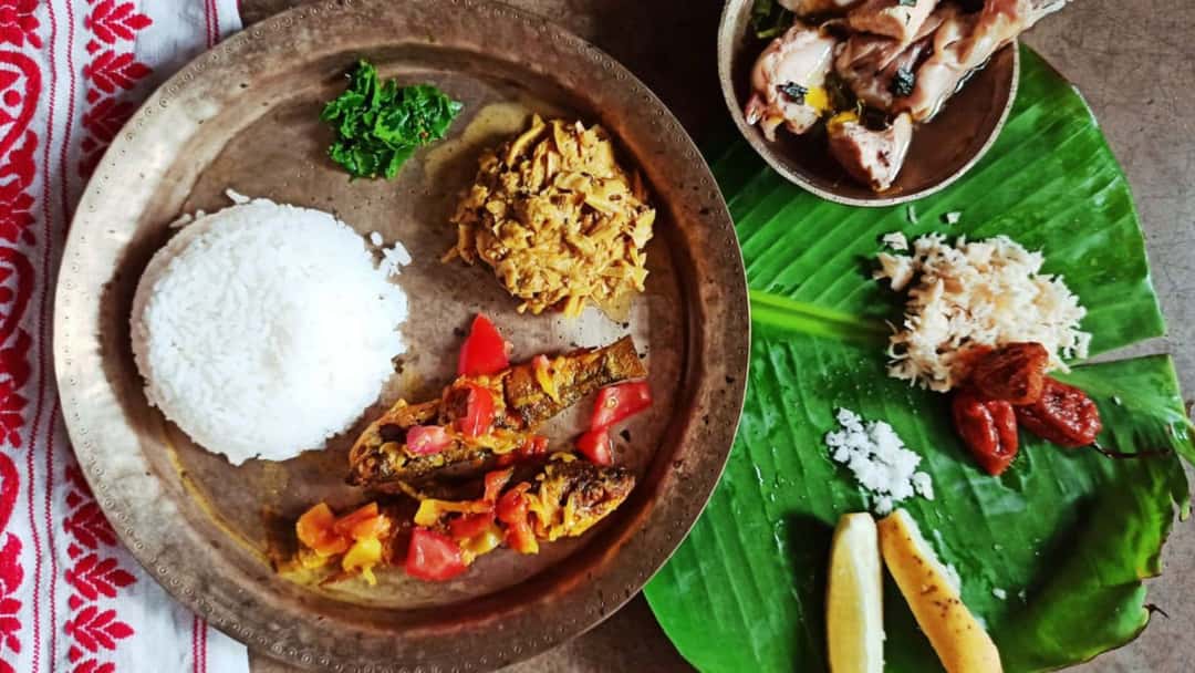 Assam thali with rice and sides.