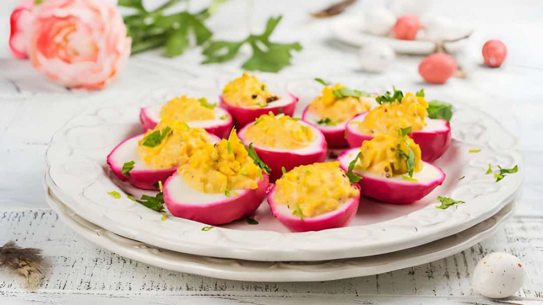 Beet-dyed deviled eggs on a plate