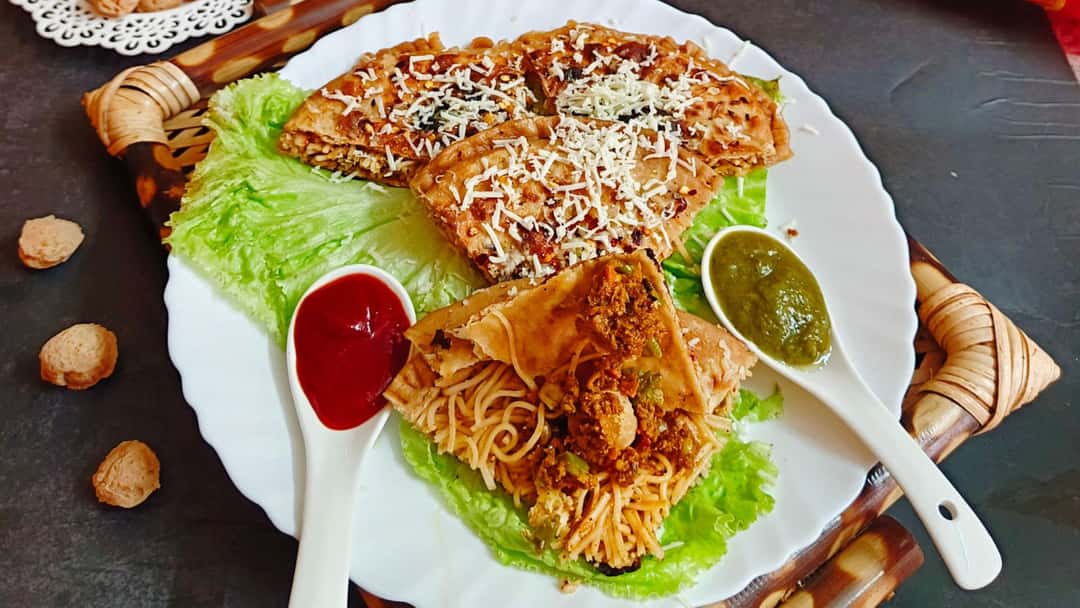 Top view of cheese, soya chowmein pizza paratha on a plate