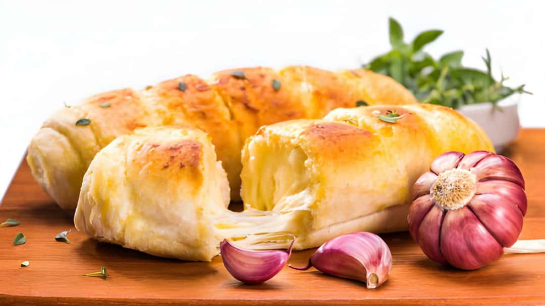 Cheese-stuffed garlic bread on a wooden board