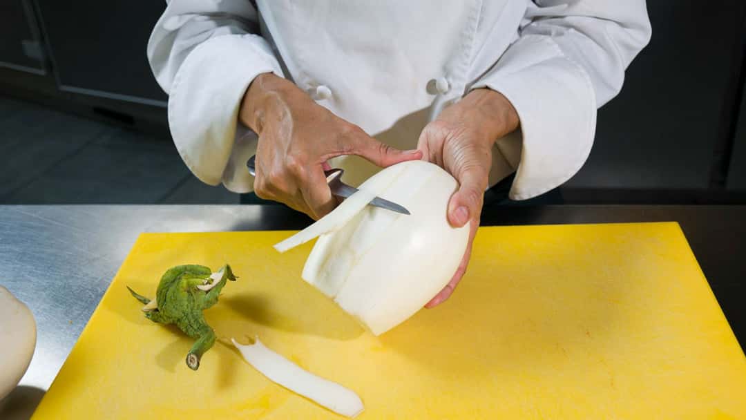 Chef peeling vegetables