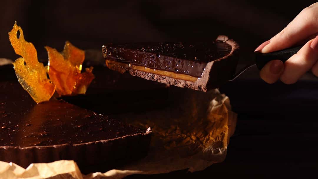 Chocolate Cake Slice Getting Lifted In A Spatula From The Whole Cake 
