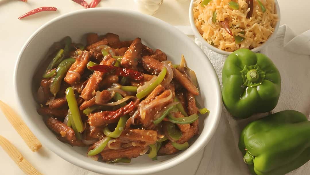 Crispy baby corn manchurian in a white shallow bowl