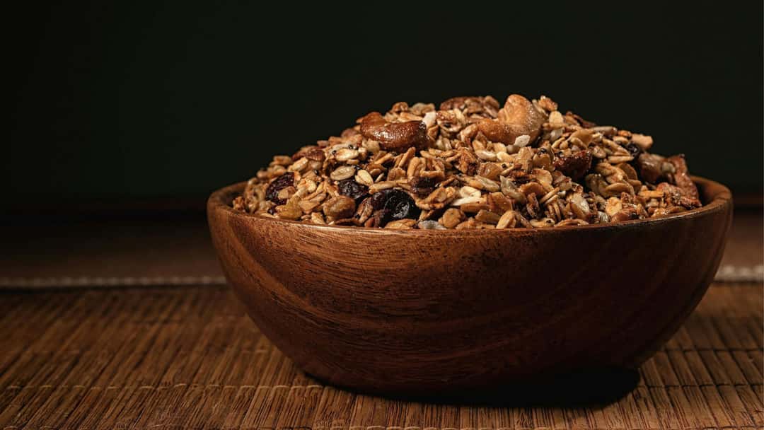 Bowl of homemade smoky savoury granola with oats, nuts, and seeds