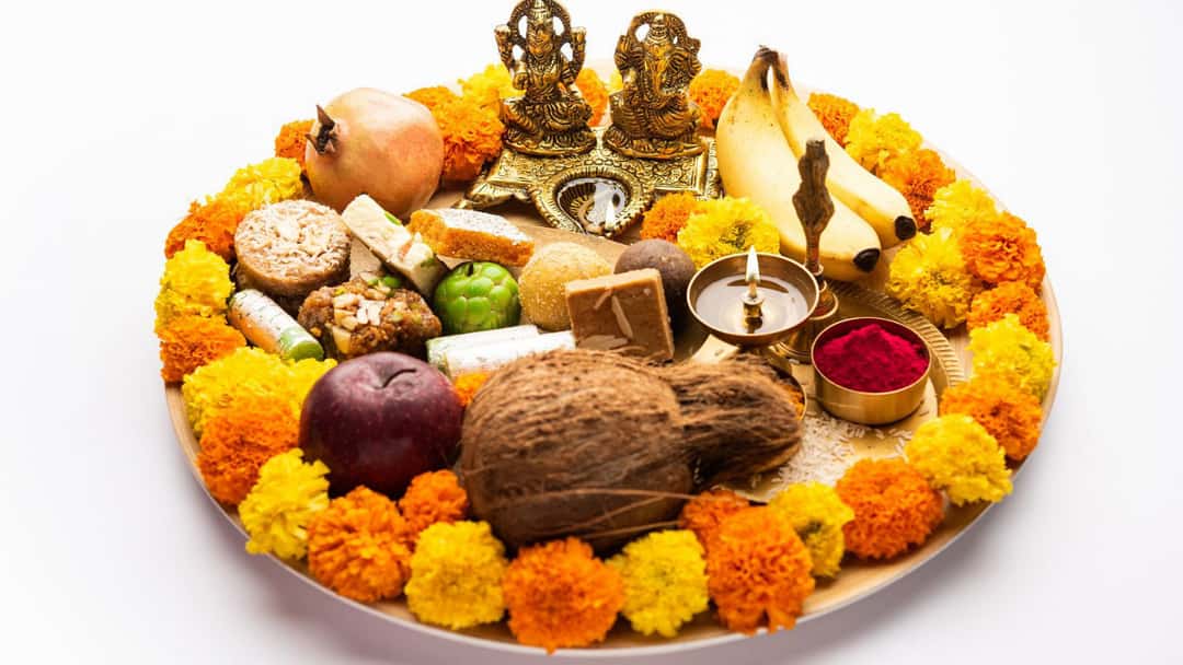 A plate of Laxmi Ganesh Puja with ceremonial food and flowers - banner image