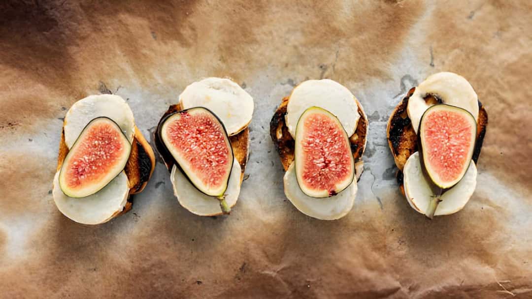 Figs and cheese canapes on a marble surface