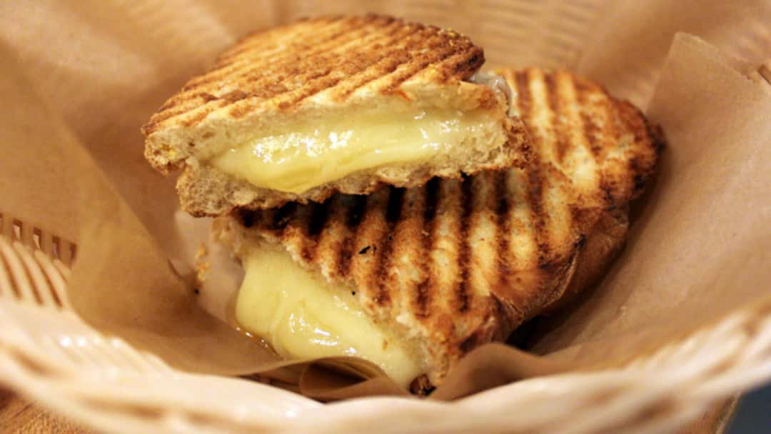 Grilled cheese sandwich in a paper brown basket - banner image