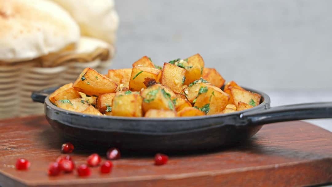 Side view of jaiphali aloo sabzi in a bowl. (banner image)