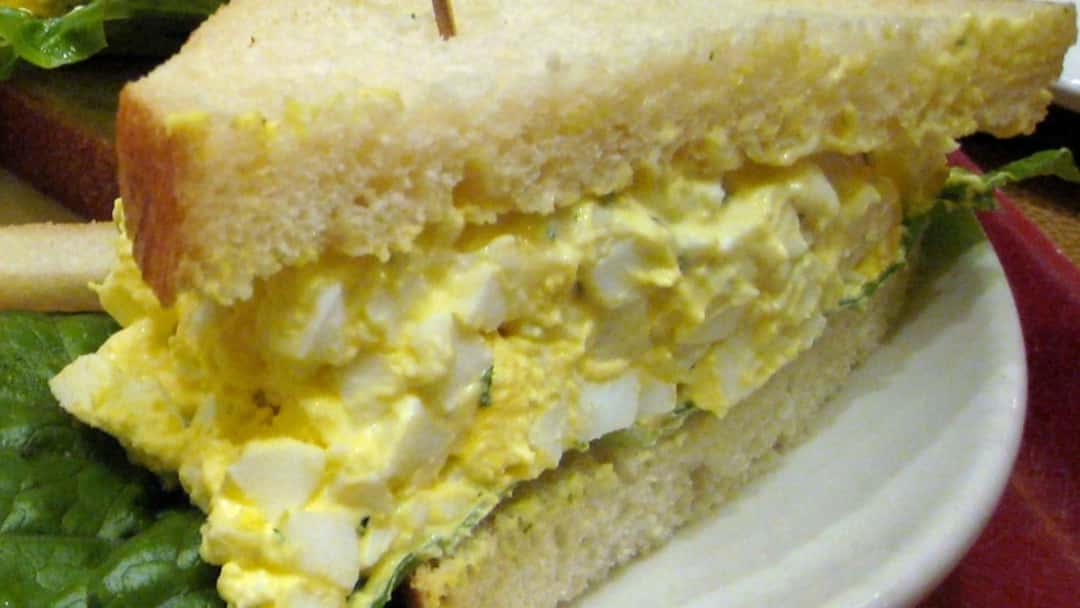 Top view of egg salad spread over a milky Japanese bread. (banner image)