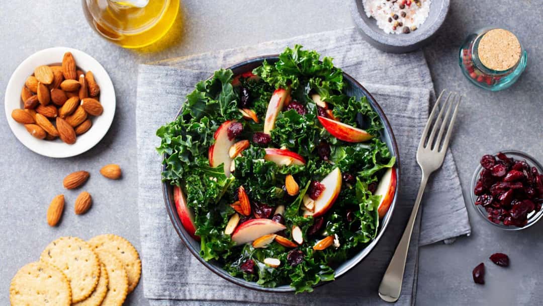 Top view of a bowl of kale and apple salad