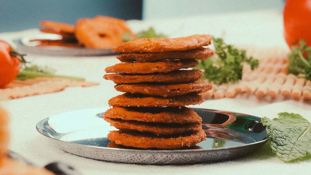 Close-up of stacked methi methri on a plate. (banner image)