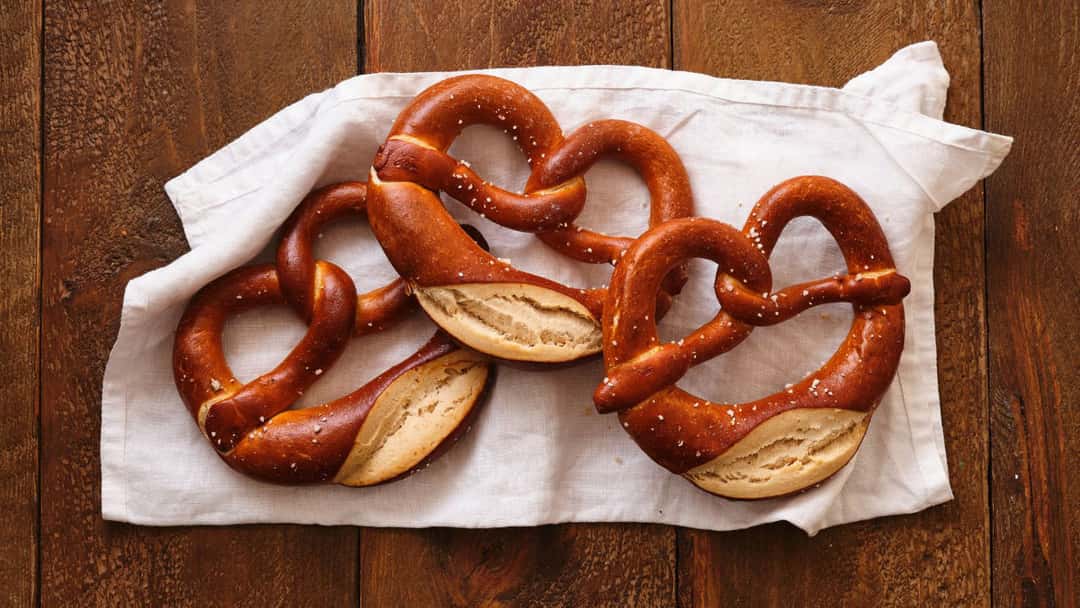 Top view of rings of khapli atta pretzels on a dish. (banner image)