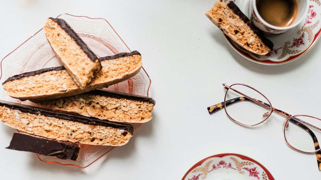 Top view of khapli atta biscotti with coffee on a surface. (banner image)