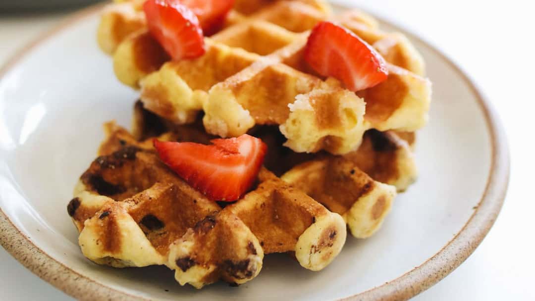 A close-up of khapli wheat chocolate chip waffles. (banner image)