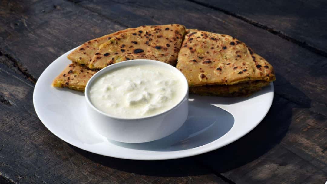 A view of khapli wheat and curd parathas on a plate