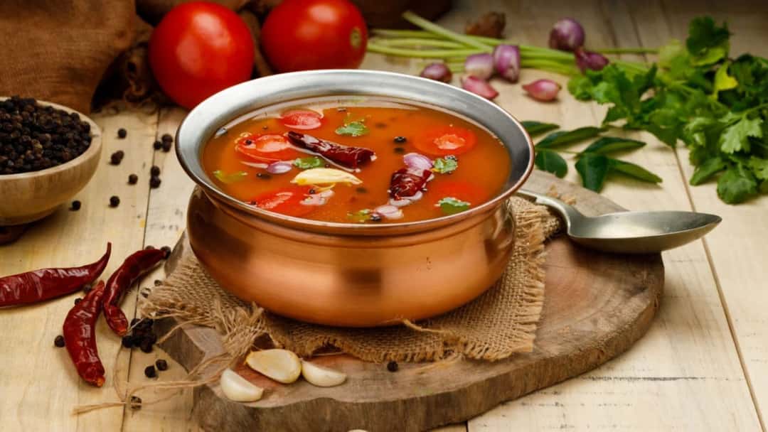Rasam in a bowl with chilli and garlic