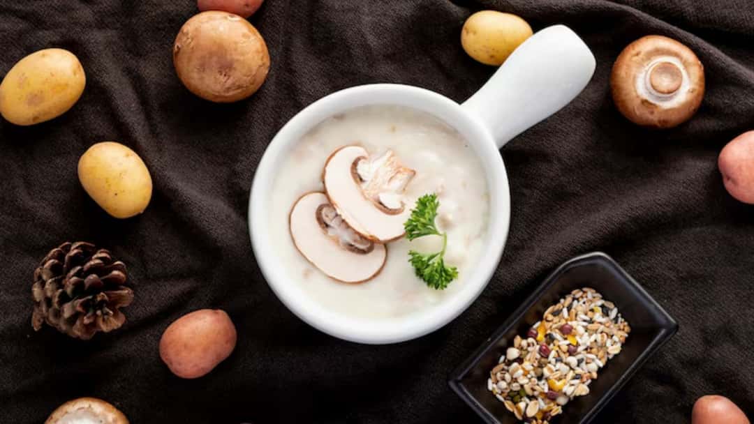 Miso mushroom soup with sliced mushrooms, spring onions and clear broth in a bowl