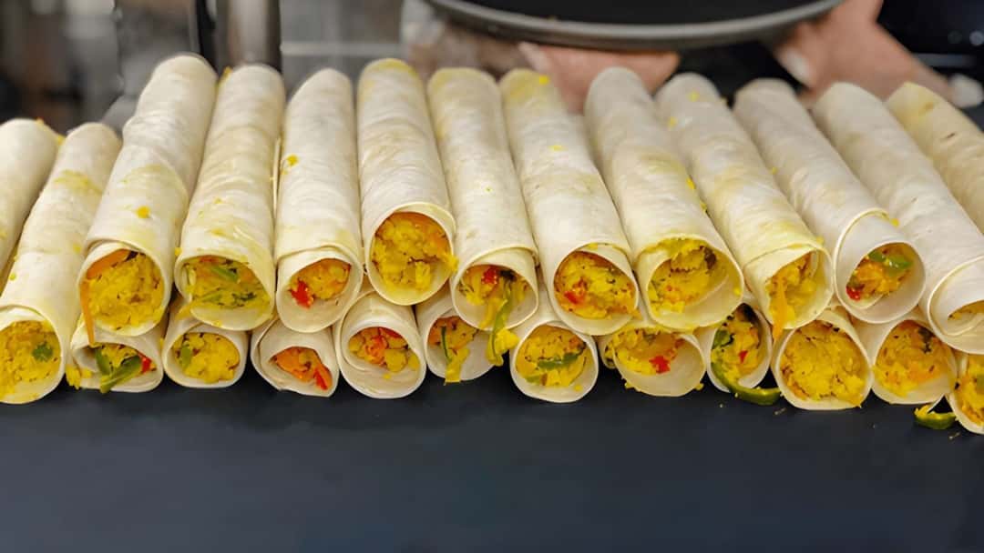 Paneer bhurji sandwich rolls on a plate with condiments