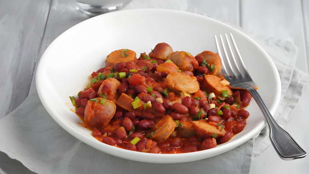 Punjabi rajma and smoked sausage in a white bowl