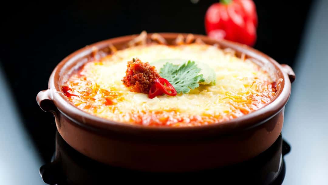 A close-up of queso fundido, a Mexican dip. (banner image)