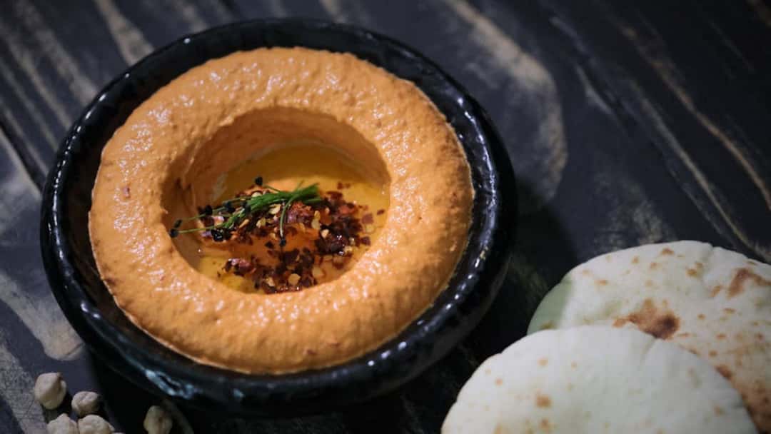 Orange hummus in focus
