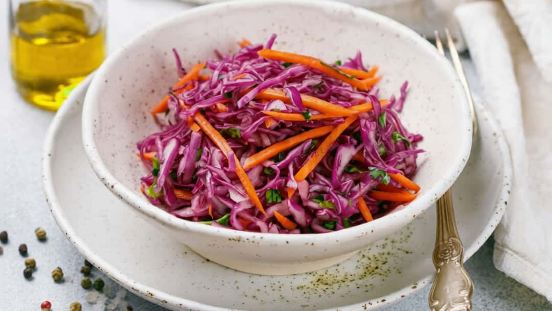 Bowl of red cabbage coleslaw with carrots