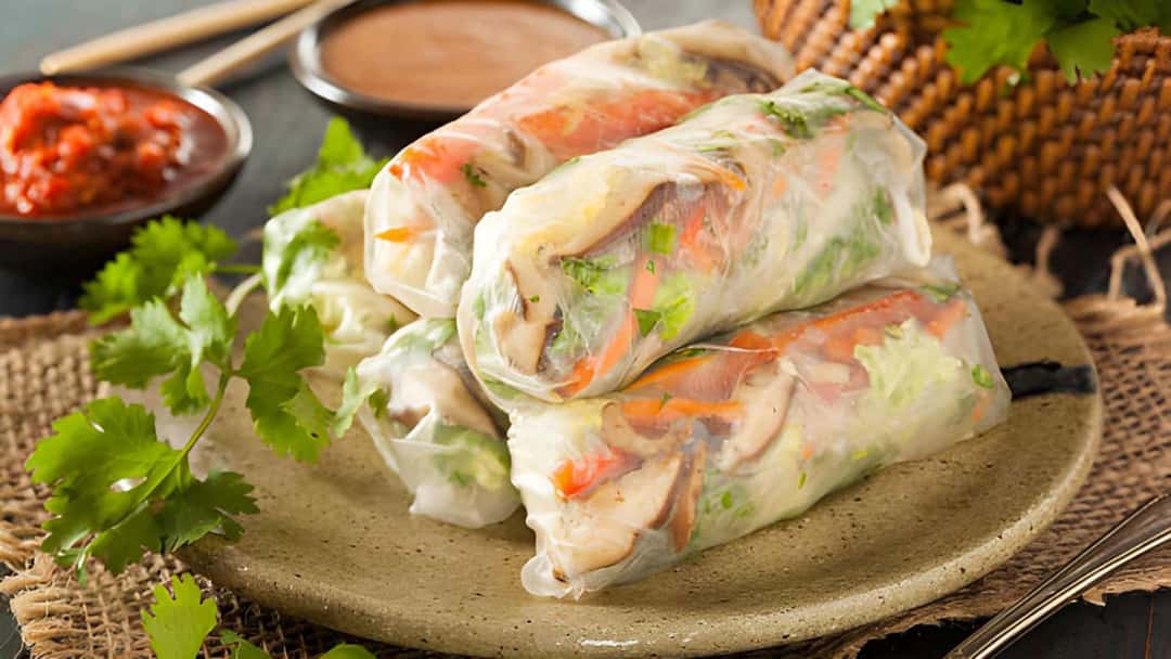 Rice paper veg rolls stacked on a plate
