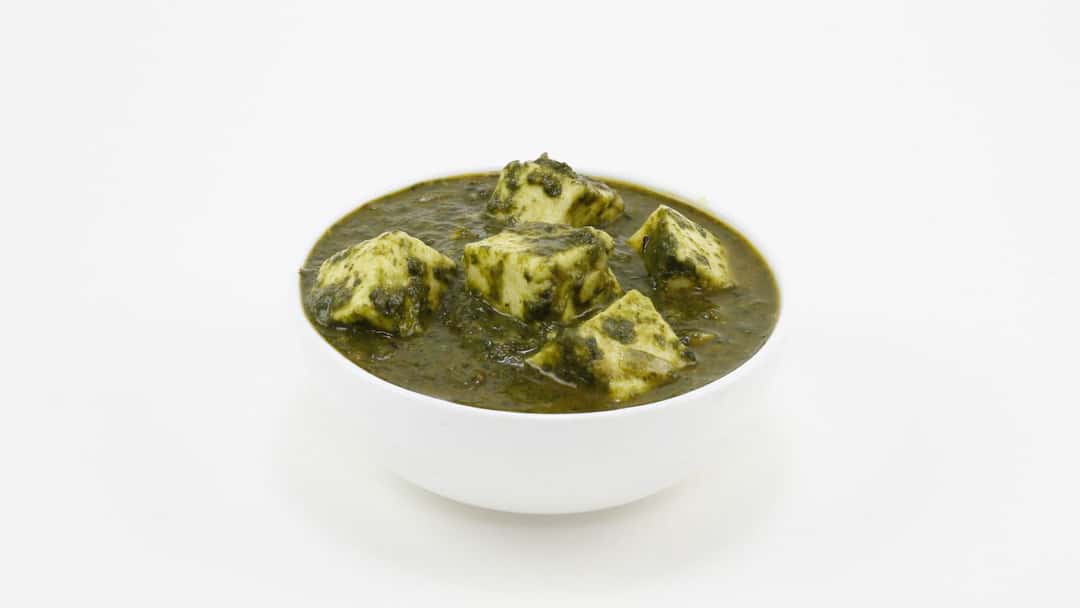 Top view of saag feta in a bowl. (banner image)