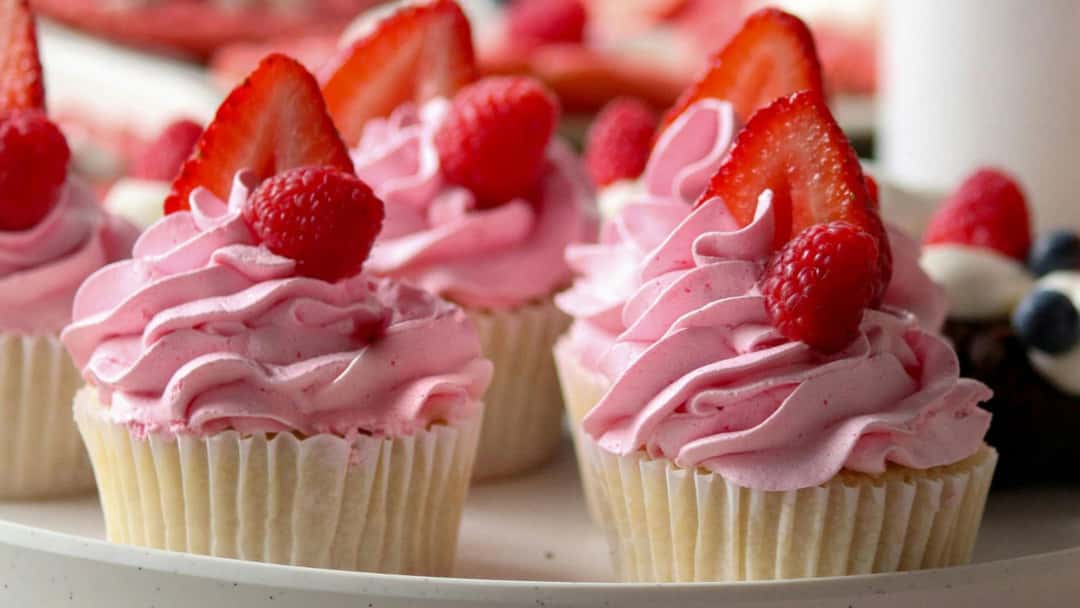 Front view of strawberry cupcakes on a plate. (banner image)