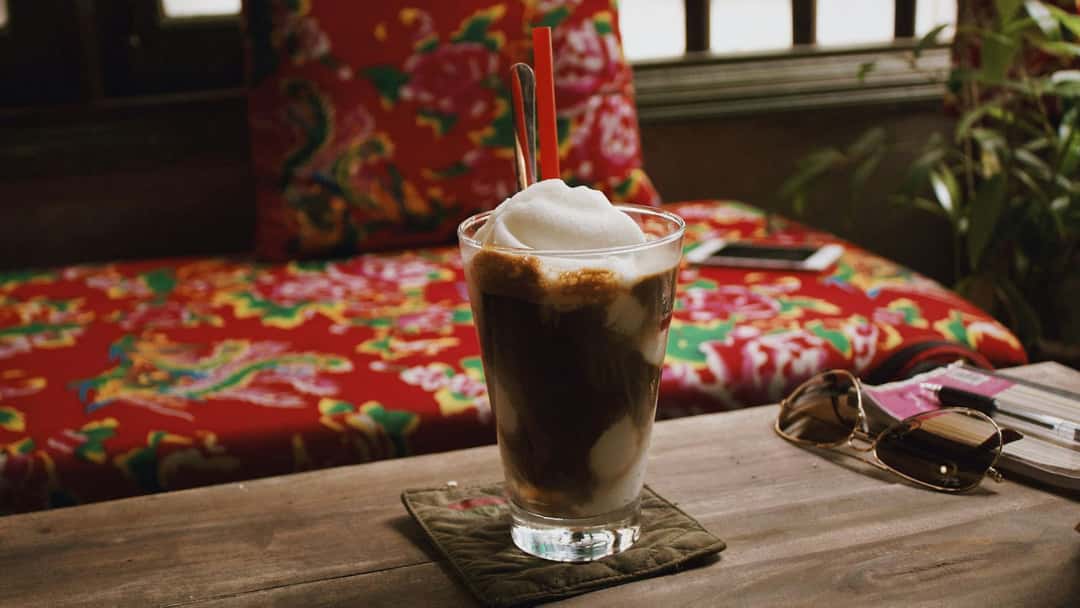 Vietnamese iced egg coffee in a glass. (banner image)