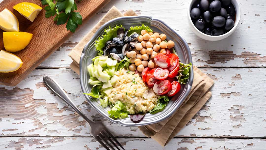 Mediterranean chickpea salad with cucumber, tomatoes, olives and fresh herbs