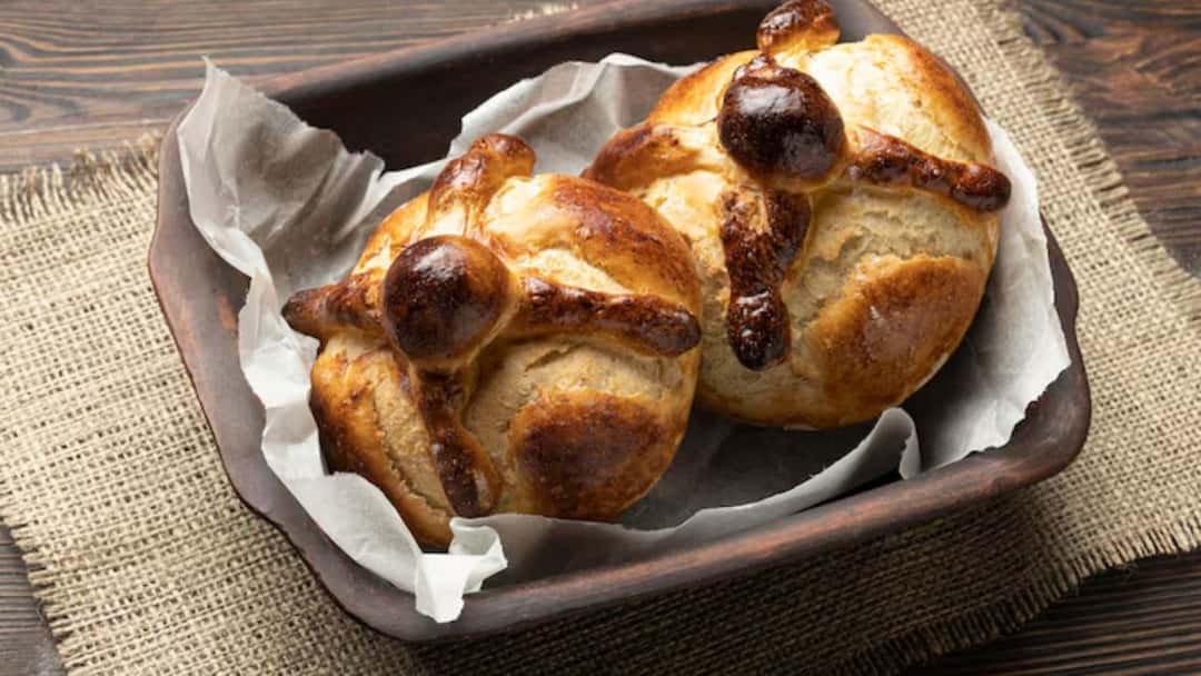Soft sourdough hot cross buns with cross markings and dried fruits