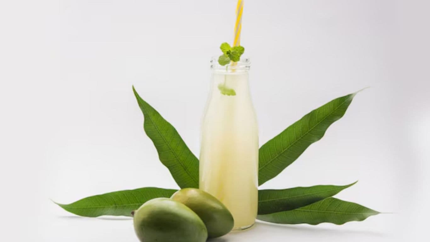 Refreshing Mango Drink in Glass Bottle with Leaves