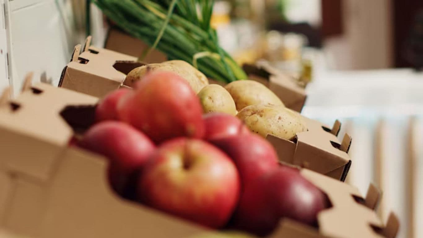 Fresh Apples and Potatoes in Cardboard Boxes