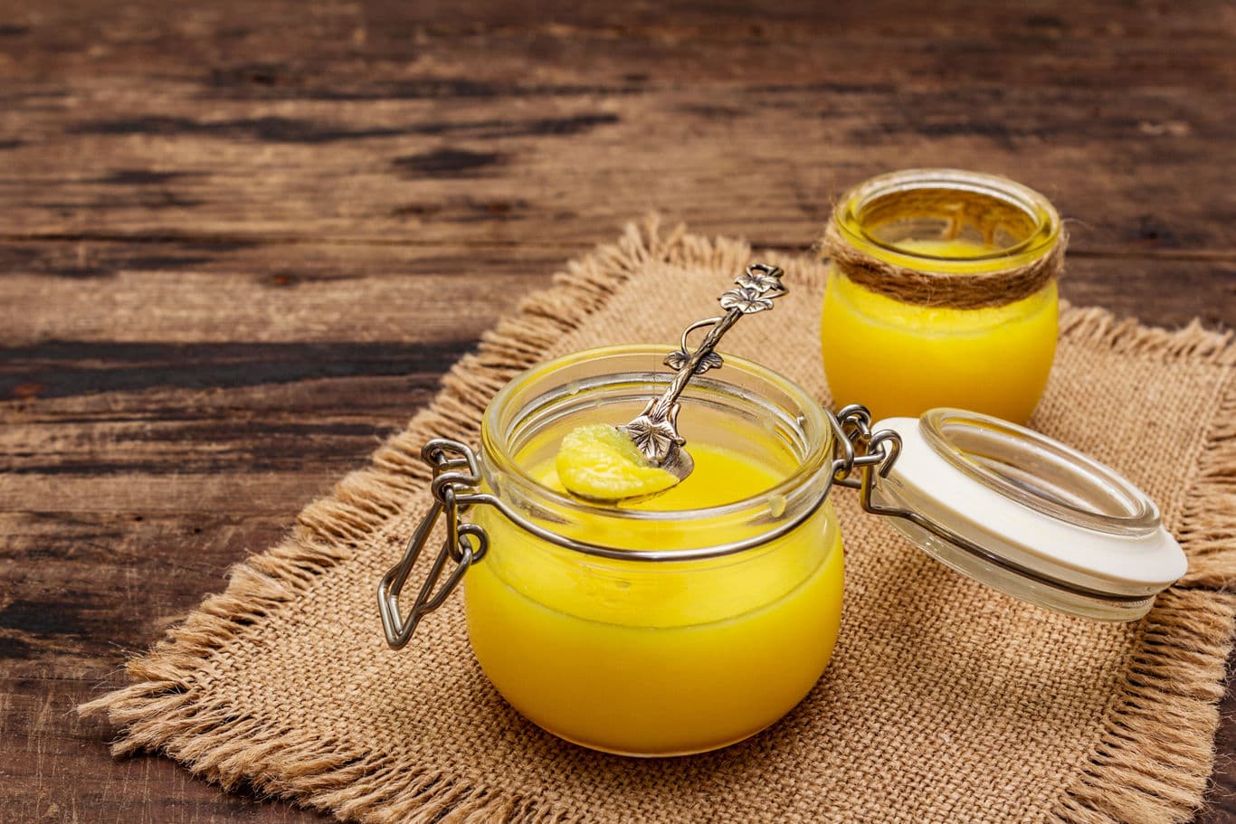 Golden homemade ghee in a glass jar