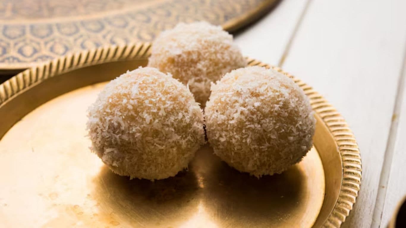 Three Coconut Ladoo Sweets on Brass Plate