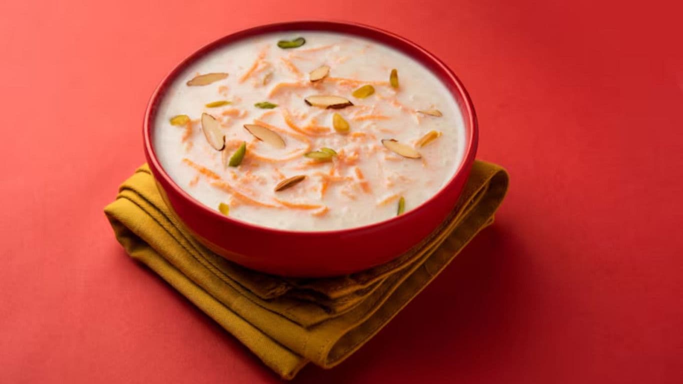 Creamy dessert in red bowl on fabric