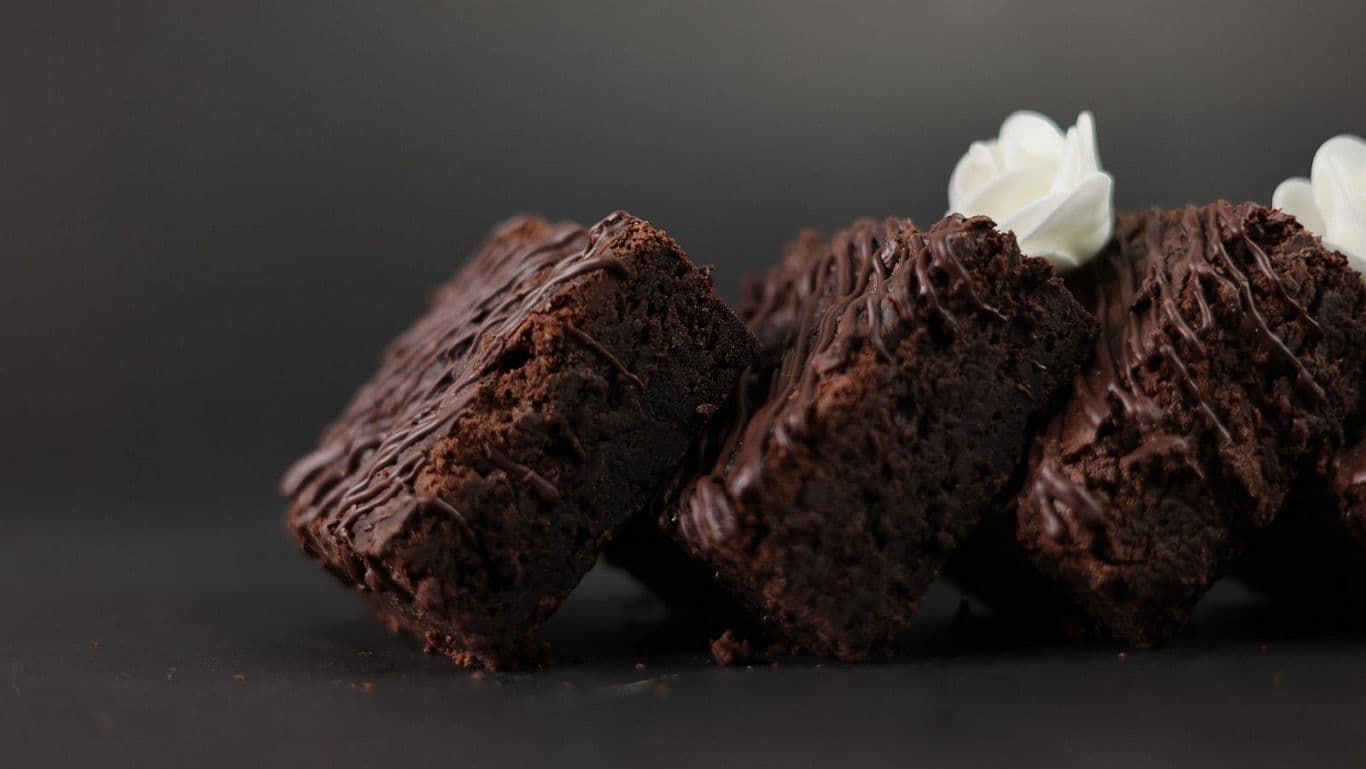 Chocolate Cake Slice Getting Lifted In A Spatula From The Whole Cake