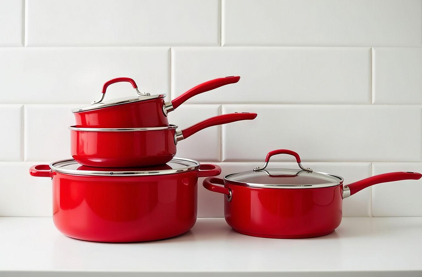 Set of red dishes. Pots and pans on white background.