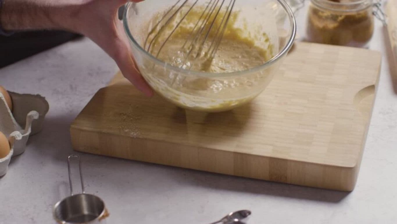 Whisking batter in glass mixing bowl