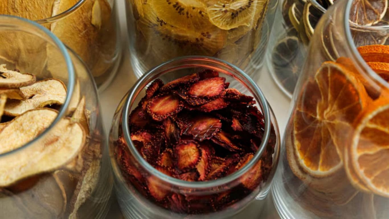 Assorted dried fruit slices in glass jars