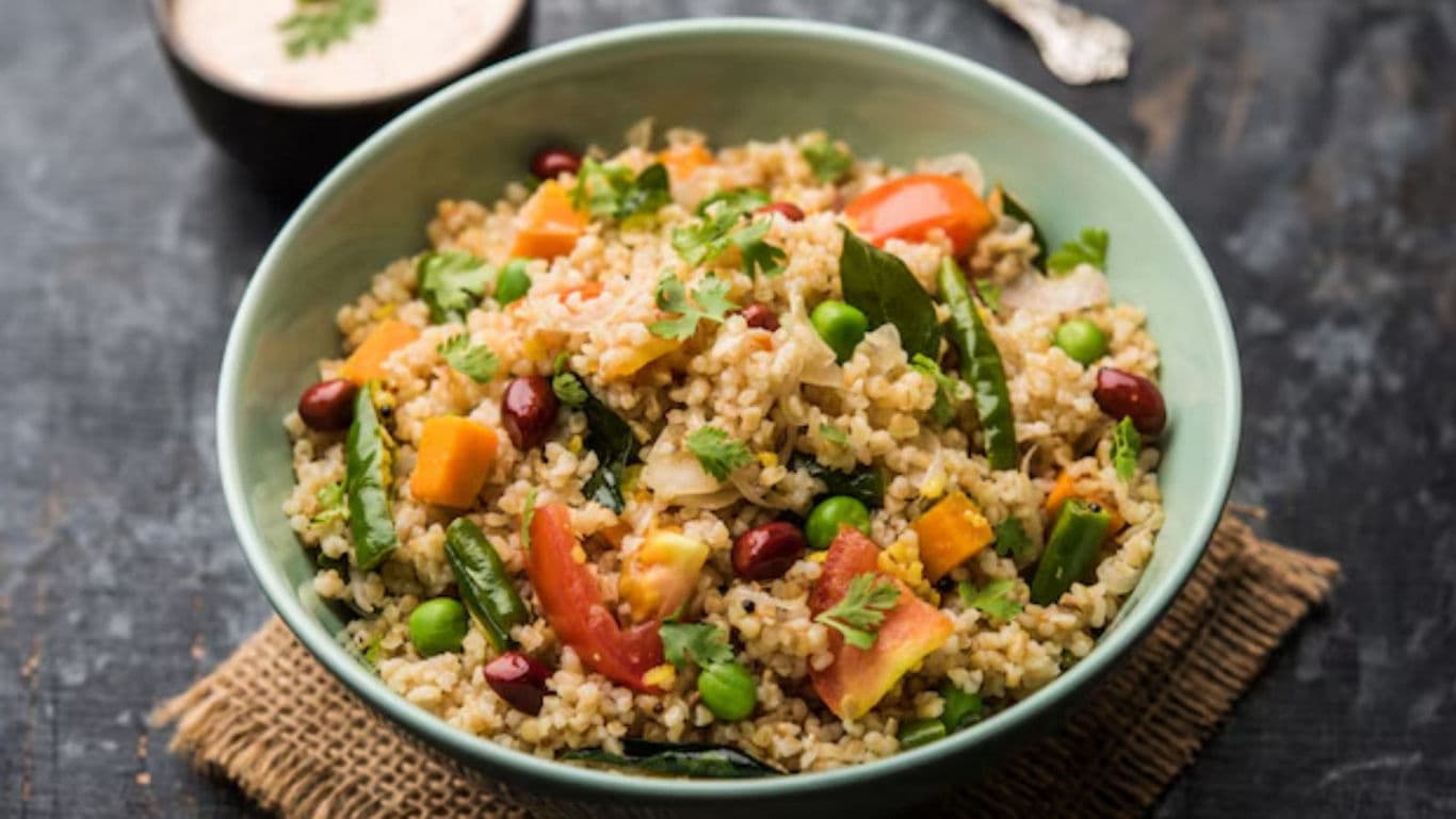 Colorful vegetable millet salad in green bowl