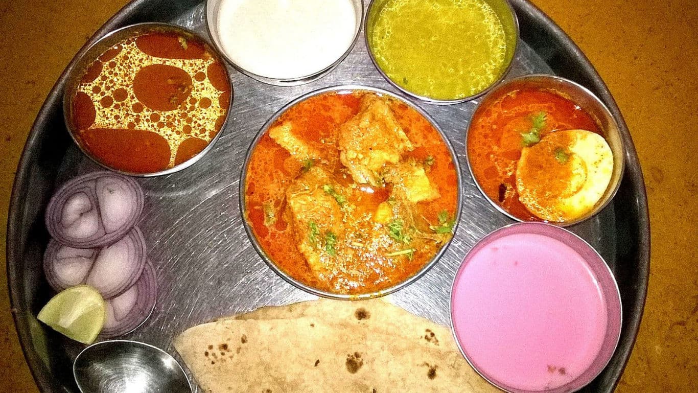 Traditional Indian Thali with Curry and Sides