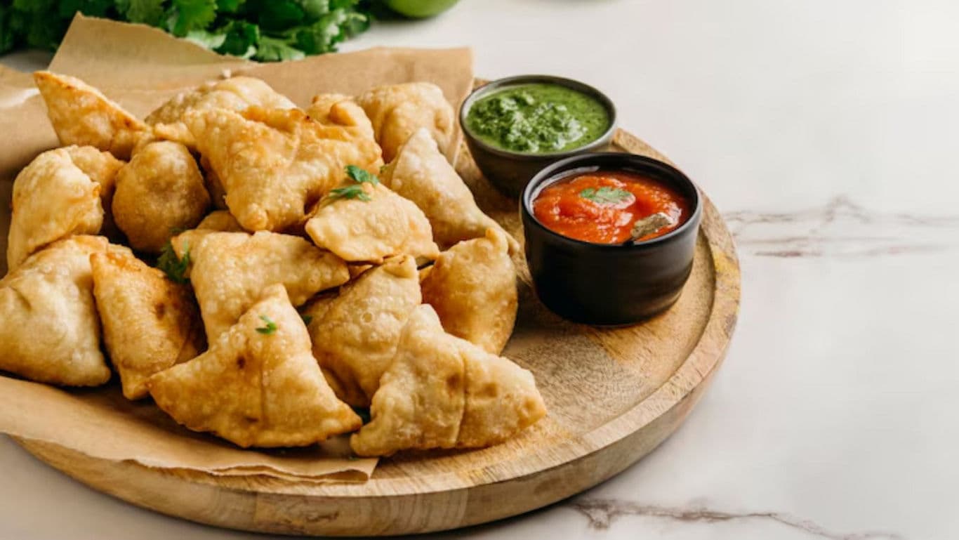 Crispy Indian Samosas with Chutney Dips on Platter