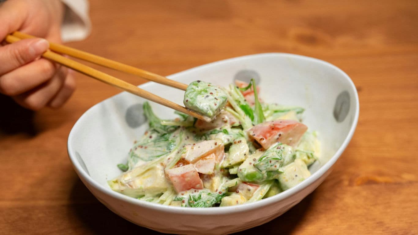 Fresh vegetable salad with creamy dressing in bowl