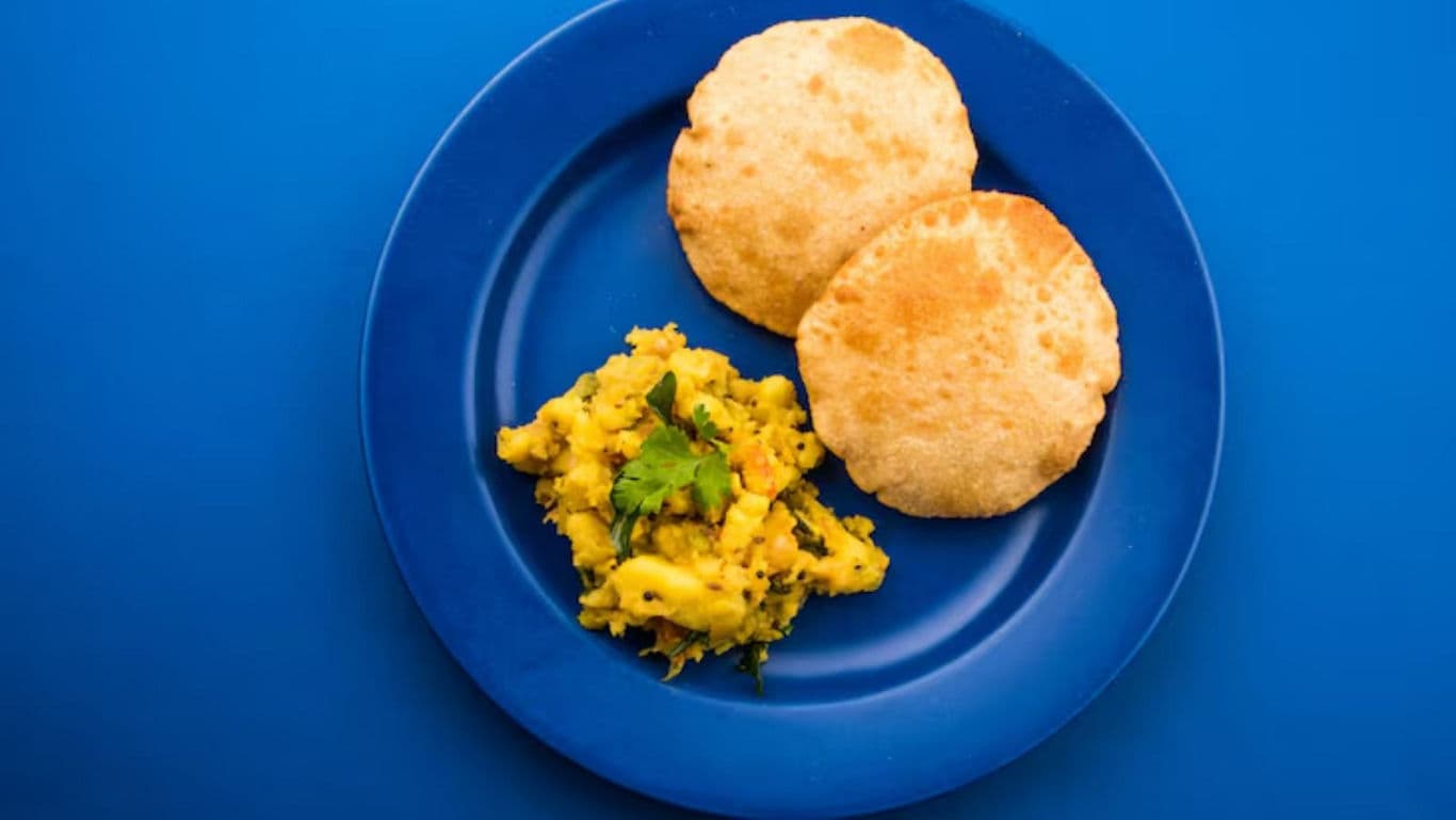 Indian Poori with Potato Curry on Blue Plate