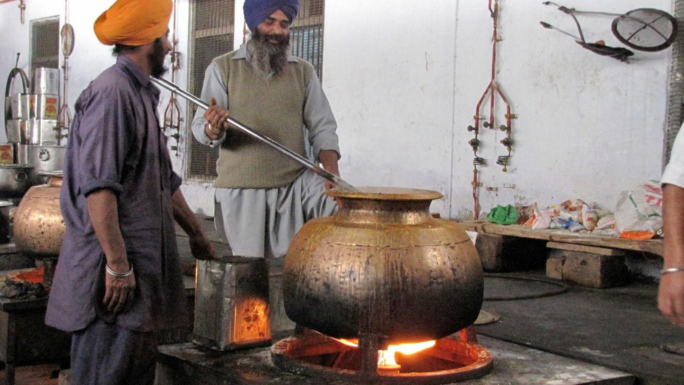 Traditional cooking in large brass pot