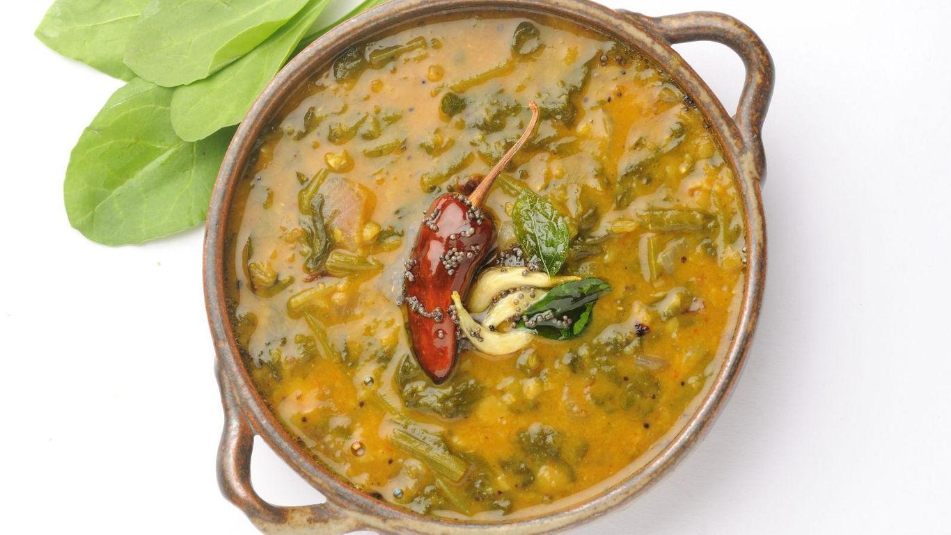 Spinach lentil curry in rustic bowl