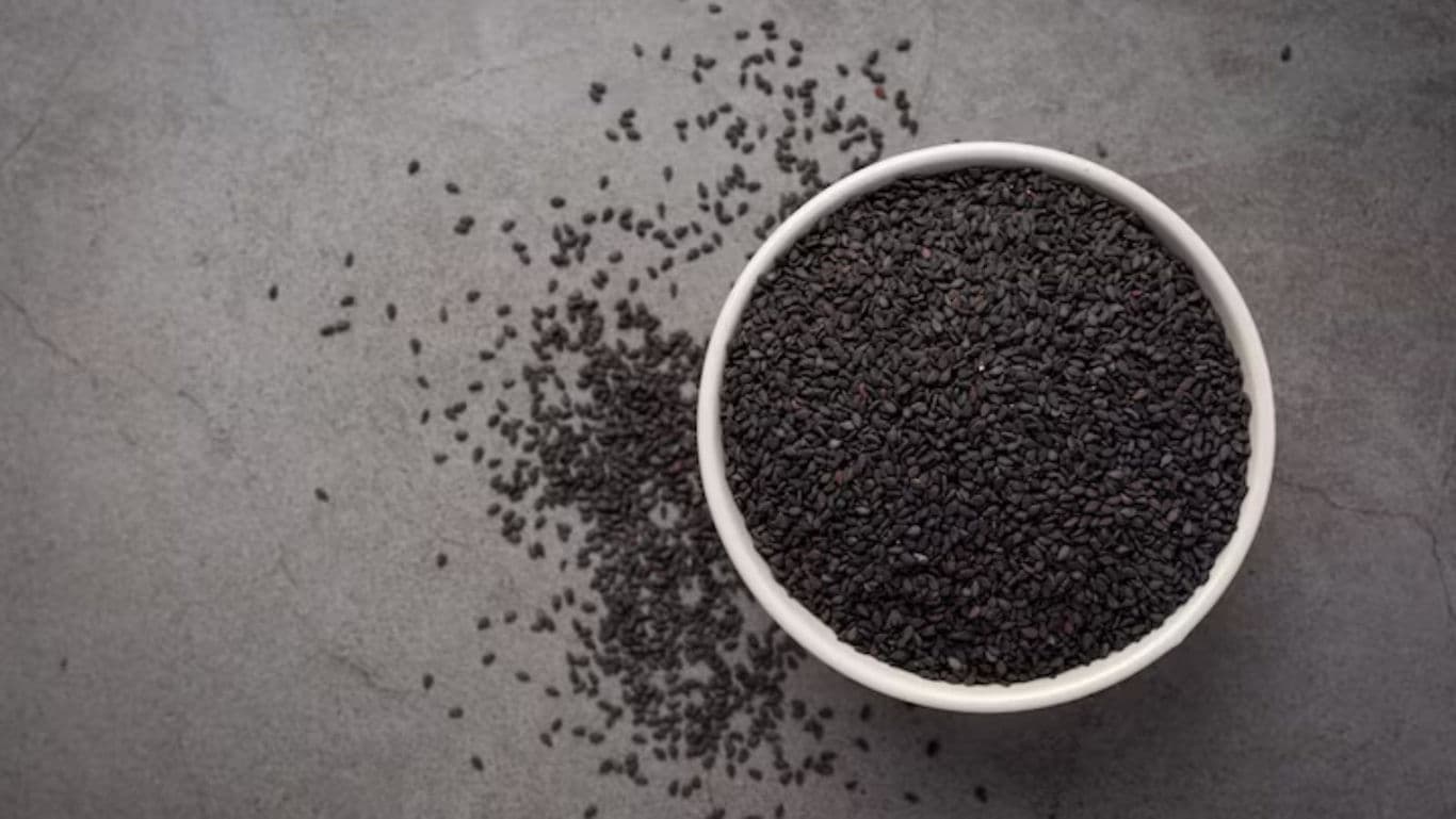 White bowl filled with scattered black seeds